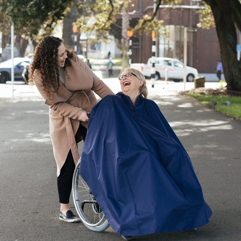 Man wearing Wheelchair Rain Coat outdoor smiling with lady